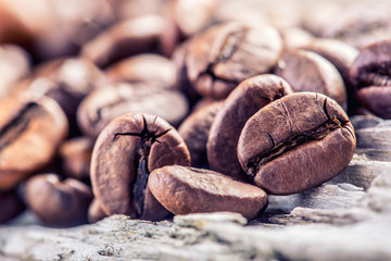 Coffee beans  on grunge wooden background.Macro