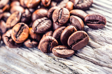 Coffee beans  on grunge wooden background.Macro