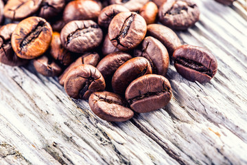 Coffee beans  on grunge wooden background.Macro