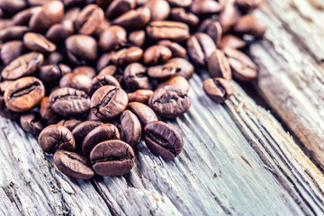 Coffee beans  on grunge wooden background.Macro