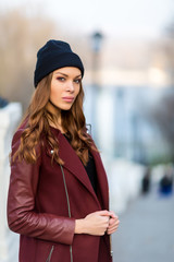 Fashion woman outdoor portrait. Beautiful girl posing on the str