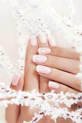 Beautiful woman's nails with french manicure. - obrazy, fototapety, plakaty