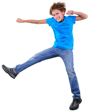 cute elementary boy  jumping and dancing over white