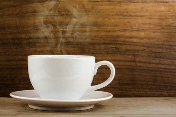 warm cup of coffee on wood background