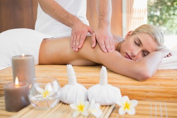 Obraz na płótnie Canvas Woman receiving back massage at spa center
