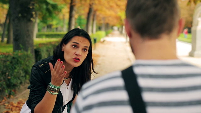 Couple having an argument in the park, steadycam shot