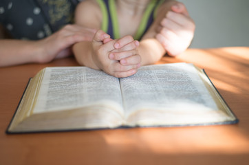Closeup of a young woman reading a large bible - 71986938