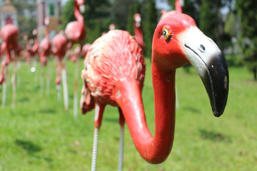 Red flamingos statue in the park. © noomcm