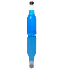Blue colored soda drinks in bottles over white background 
