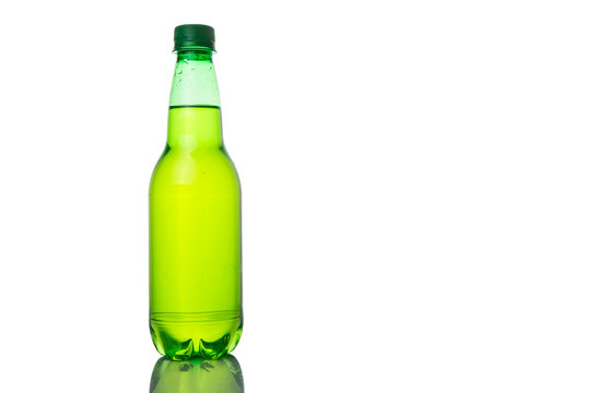 Green colored soda drinks in bottles over white background 