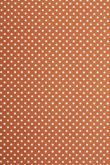 Close up of orange and white spotted textile