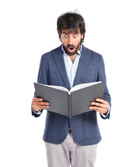 Surprised man reading a book over white background