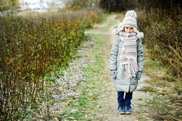 KId girl in the autumn forest