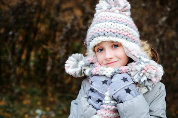 Portrait of adorable girl outdoor in winter park