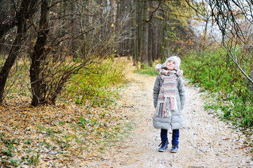 KId girl in the autumn forest