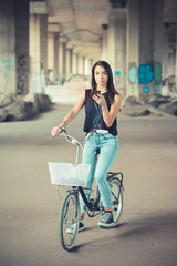 Fototapeta na wymiar young beautiful brunette straight hair woman using bike and smar