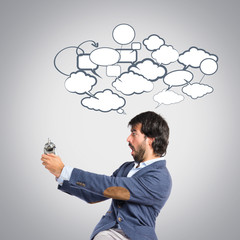 Man holding a clock over grey background