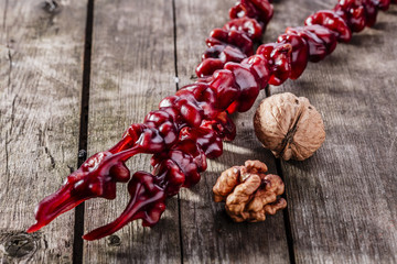 churchkhela walnut red on a wooden surface