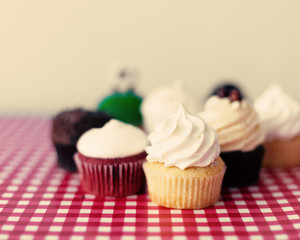 Vintage cupcakes over checkered tablecloth