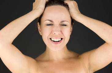 Naklejka premium model isolated on plain background stressed upset pulling hairs