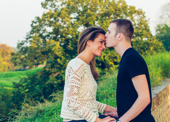 Young happy couple posing outdoor. Autumn scenery.