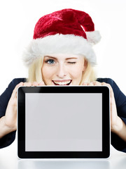 Woman as Santa winking over her tablet pc