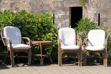 rattan chairs against the the historic wall
