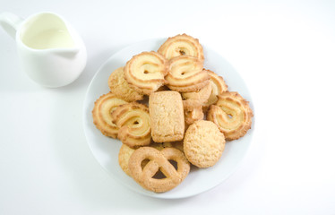 Obraz na płótnie Canvas Danish cookies seved with jug of milk isolated on white backgro