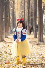 little girl dress in snow white costume in forest