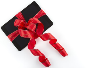 Tablet pc with  Christmas red ribbon