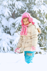 Little child playing in snow