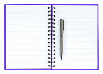 Silver ball point pen on purple notebook