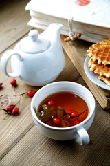 Rosehip tea with books in the background