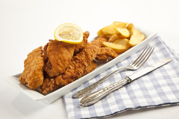 Viener chicken fries, breaded steak with french fries and lemon