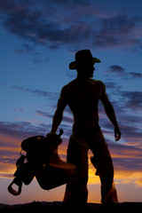 silhouette cowboy no shirt hold saddle look side