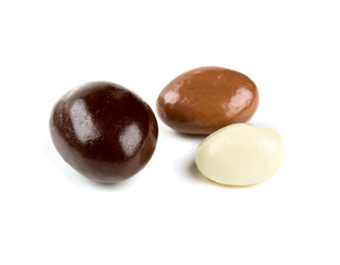 chocolate covered nuts and raisins isolated on white