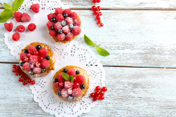 Naklejka na ściany i meble Sweet cakes with berries on table close-up