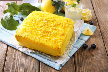 Tasty lemon cake on wooden table