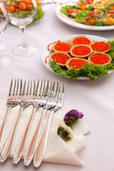 Buffet table with dishware waiting for guests