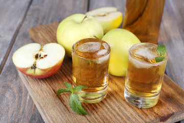 Still life with tasty apple cider in barrel and fresh apples