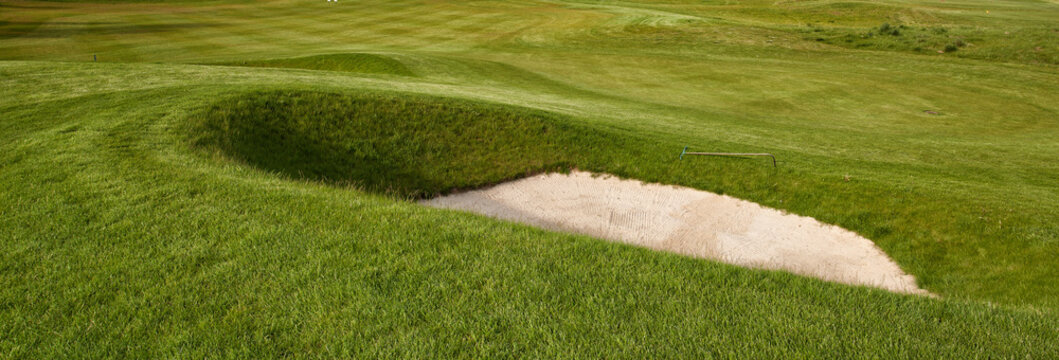 Deep golf bunker on a summer golf course