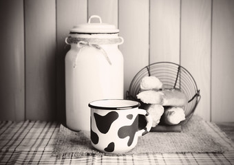 Retro still life with tasty rustic milk, on table