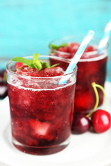 Closeup of cherry granita in glasses, on color wooden