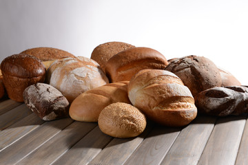 Fresh bread on table on white background