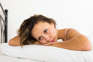 Fototapeta premium Upset woman laying in bed