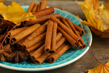 Cinnamon sticks and stars anise with yellow leaves