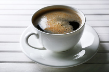 Cup of coffee on wooden table