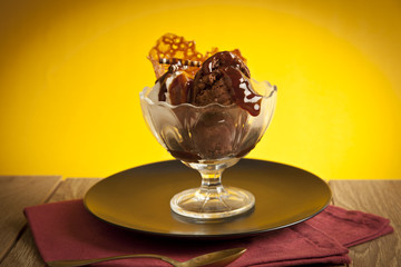 Ice cream in sundae cup on yellow background