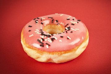 Donut with Pink and Yellow on Red Background