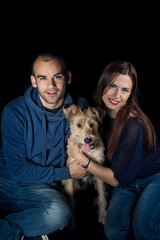portrait of couple and their cute dog